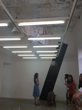 展厅上方的日光灯架上揉皱的喷绘打印作品
展厅上方的日光灯架上揉皱的喷绘打印作品